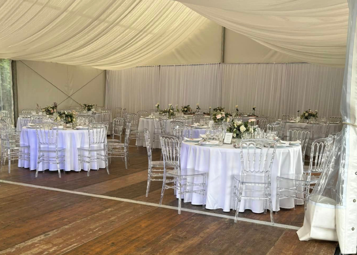 Salle de réception décorée de blanc et fleurs fraîches pour un mariage organisé par Traiteur Péberat Cédril